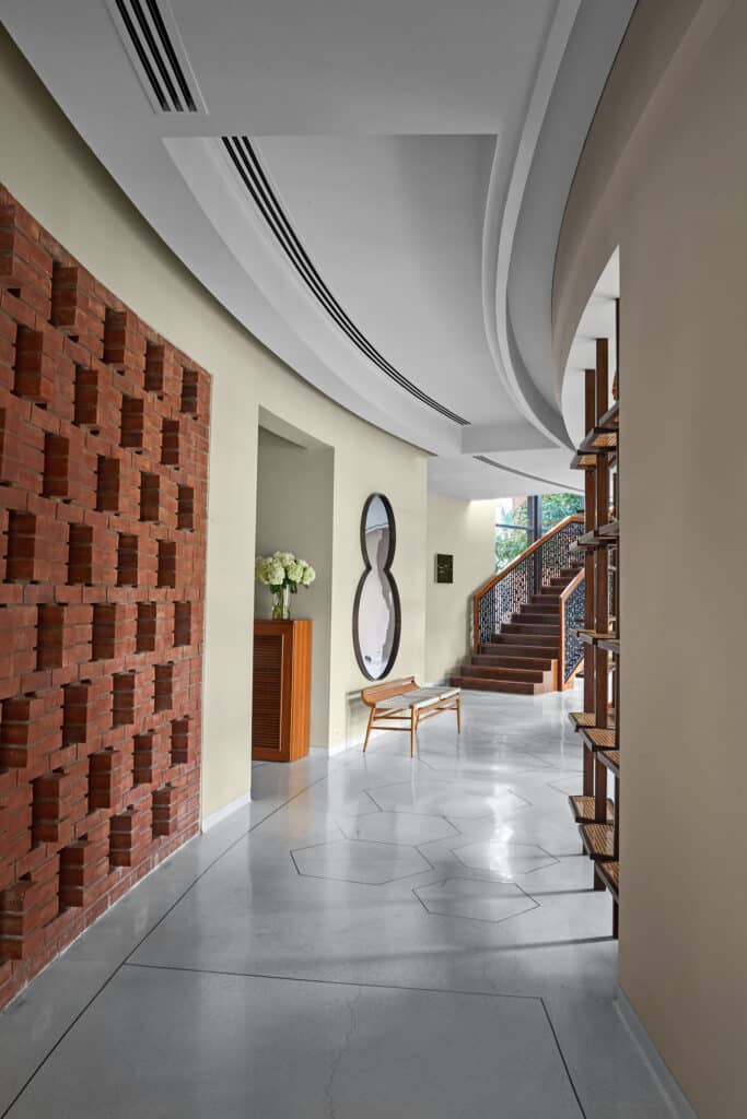 beautiful curved hallway leading to the staircase