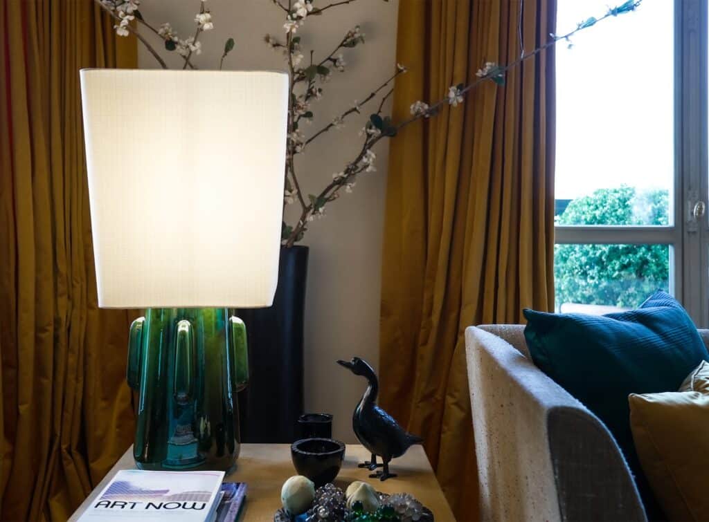 toshiro green table lamp on side table by kira 